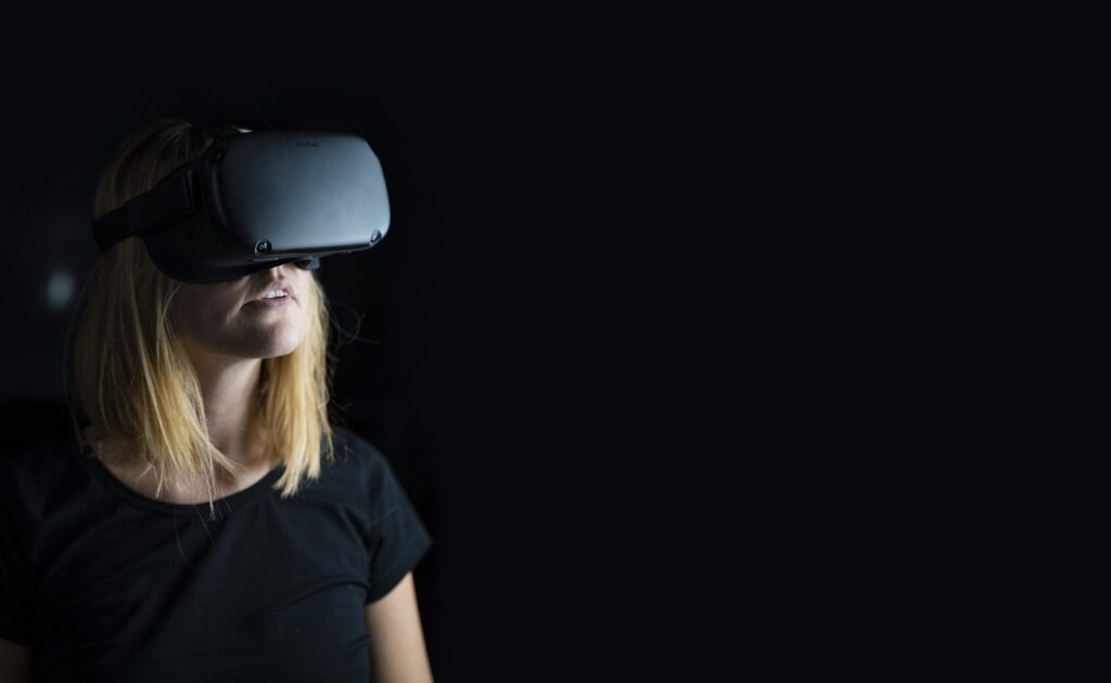 A woman wearing a virtual reality headset and enjoying the Virtual Tour of TD garden.