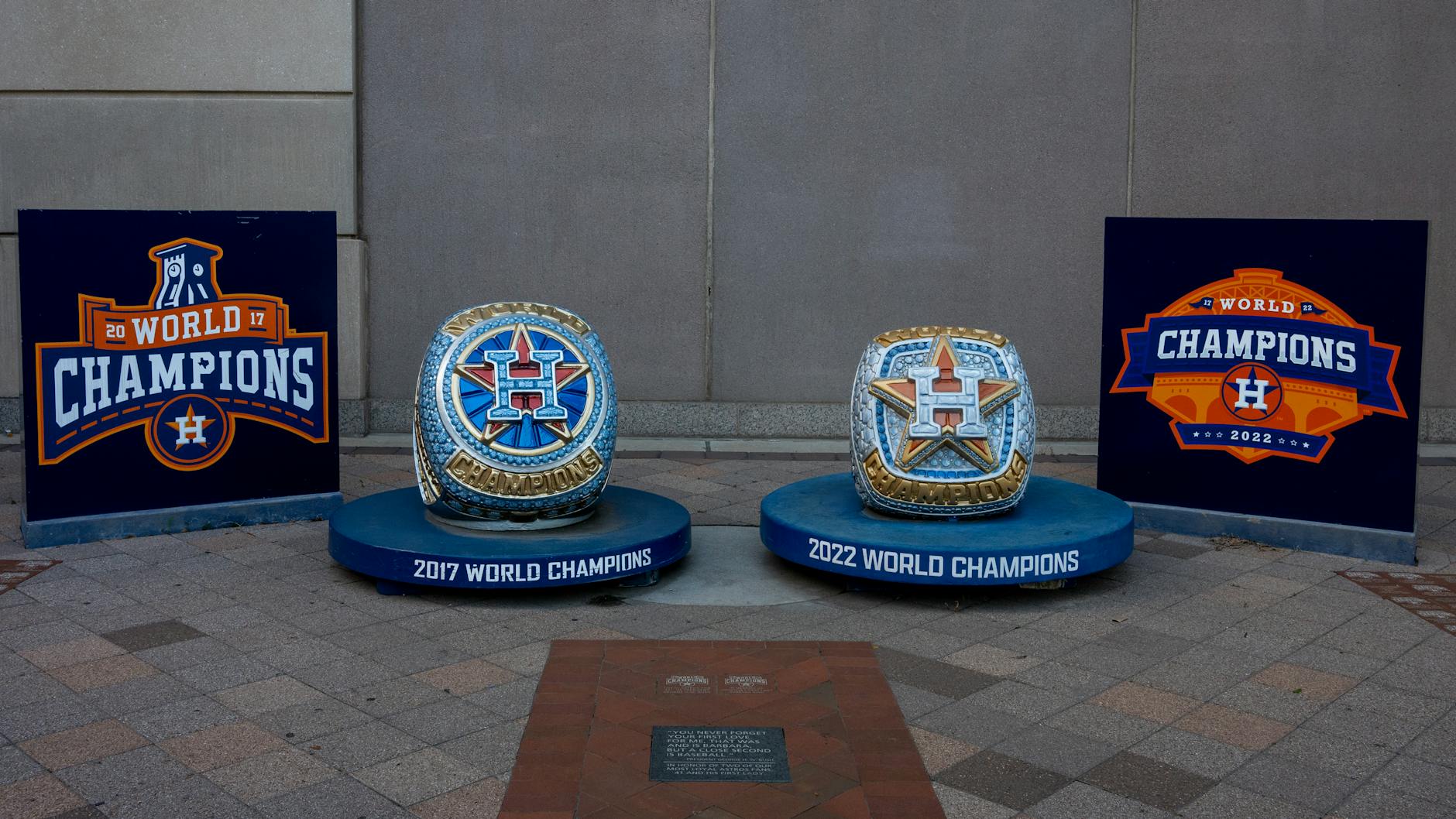 a group of blue and gold trophies on a brick surface