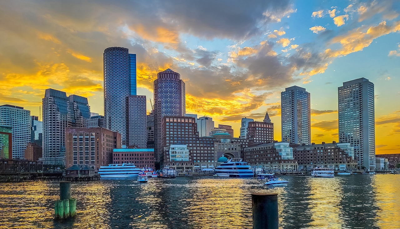 a city skyline with boats on the water